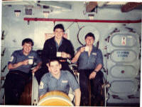 Brum, Dave, Stawbs and Sid sat on the 182 torpedo decoy Quarterdeck POS 1983